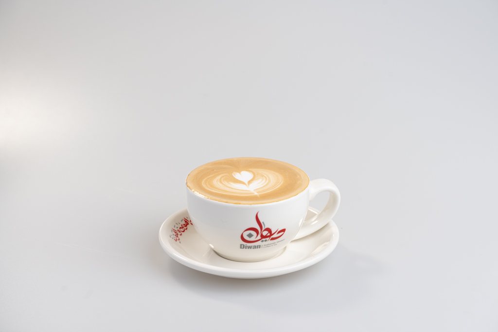 Hot latte with latte art in a Diwan cup